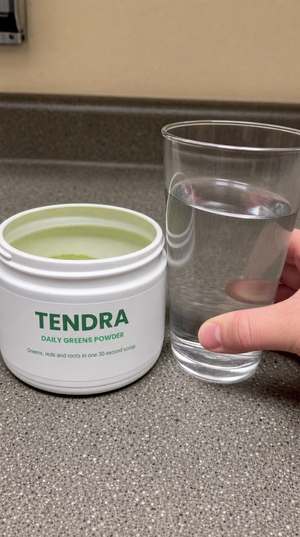 Tendra tub and a glass of water on a break-room counter